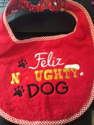 Adult Bib in red with slogan "Feliz Naughty Dog"