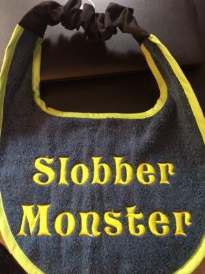 Alternative view of Adult Bib two colours & slogan "Slobber Monster"
