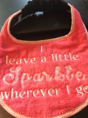 Adult Bib Pink with slogan "I leave a little Sparkle wherever I go"