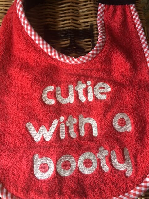 Adult Bib with slogan "Cutie with a Booty"
